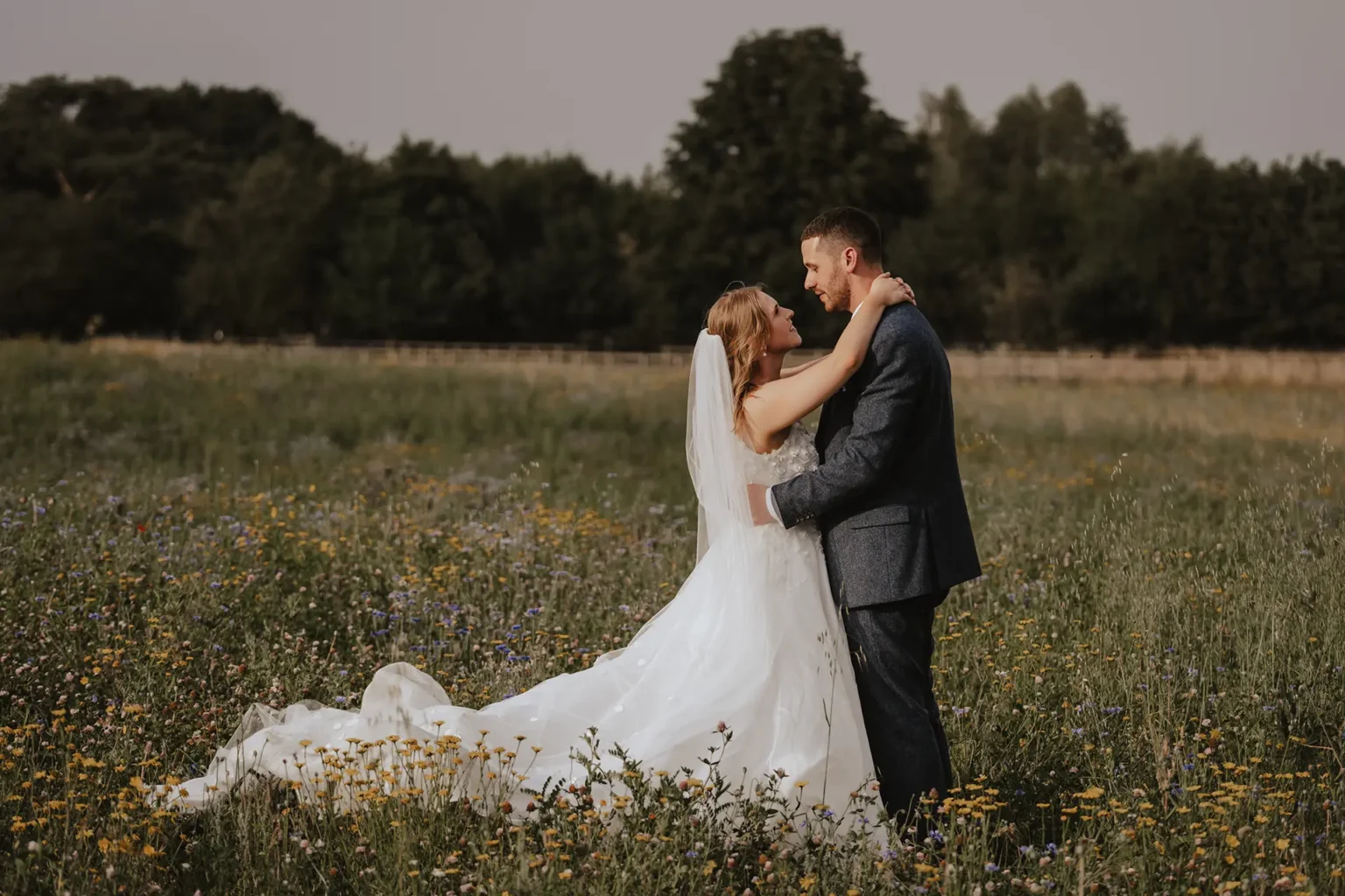 Mythe Barn bride and groom wildflowers